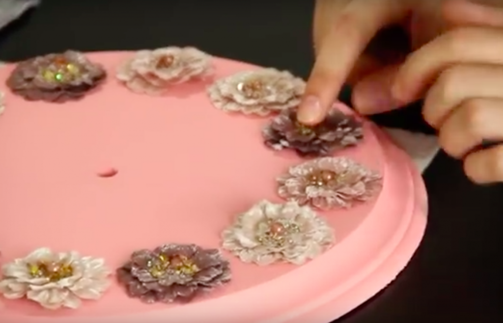 The Flowers She Is Gluing To This Piece Of Wood Are Not Only Pretty