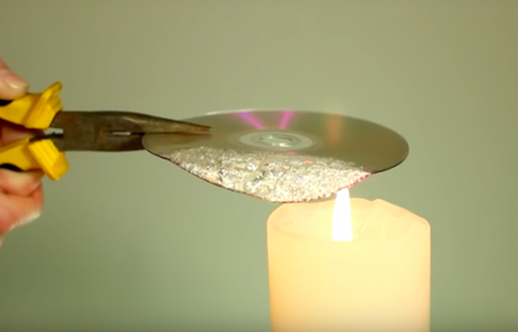 She Holds A CD Over A Small Flame And With That One Step She Makes