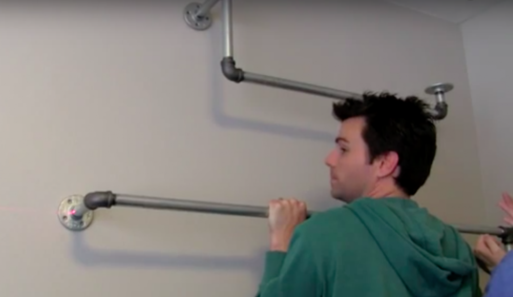 He Installs This Galvanized Pipe Right Into The Wall For An Easy And