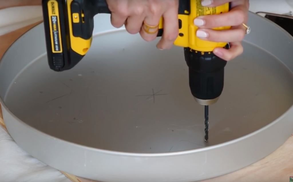 She Is Drilling Holes Into A 16" Cake Pan To Make A MindBlowing Table